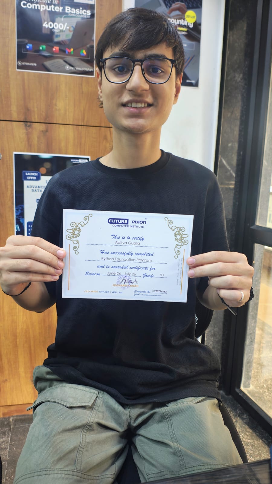 Aditya Gupta holding his Future Vision certificate